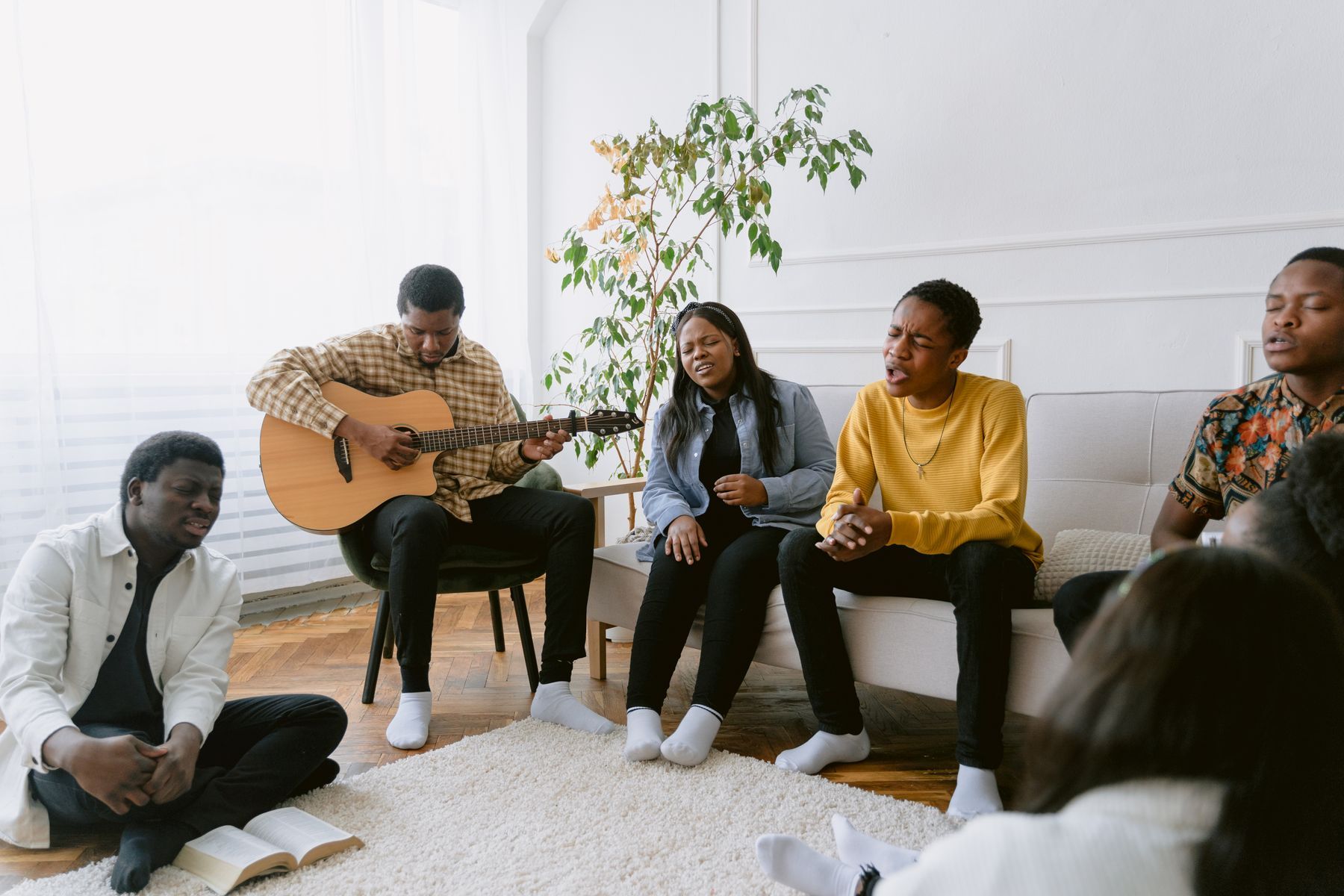 Friends singing together with a guitar