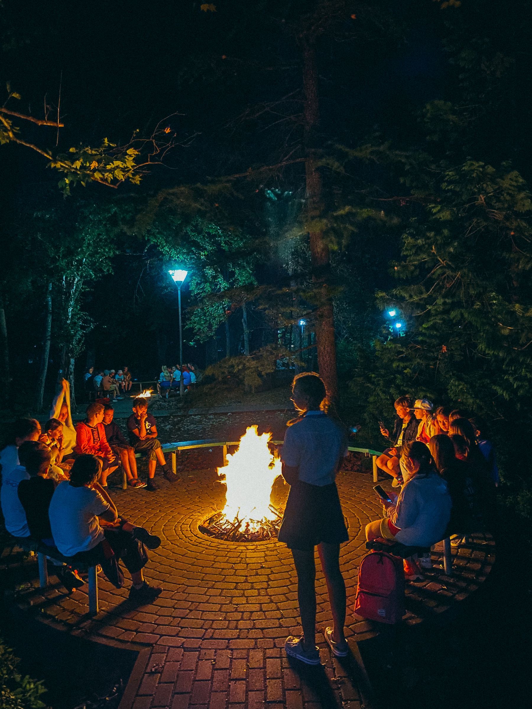 People gathered around a campfire at night